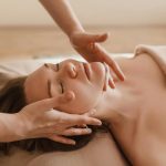 Woman receiving a soothing facial massage, promoting relaxation and wellness.